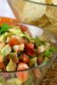 A bowl of diced shrimp, tomatoes and avocados.