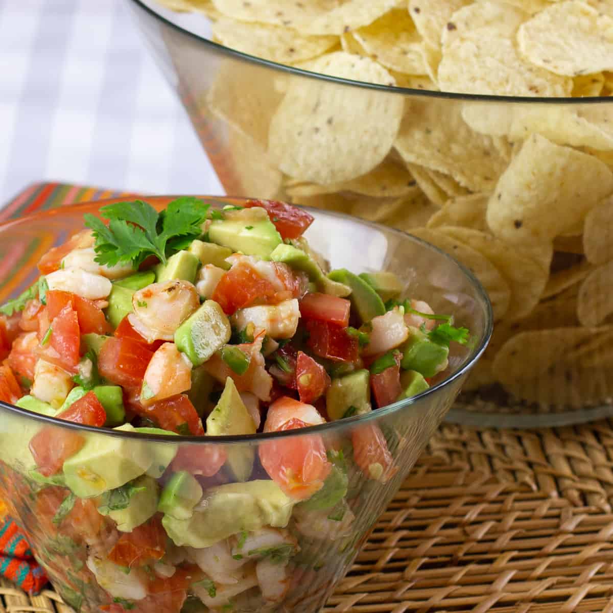 A close up picture of a bowl of shrimp and avocado salsa.