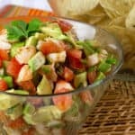 A bowl of salsa made with diced shrimp, avocado and tomatoes.