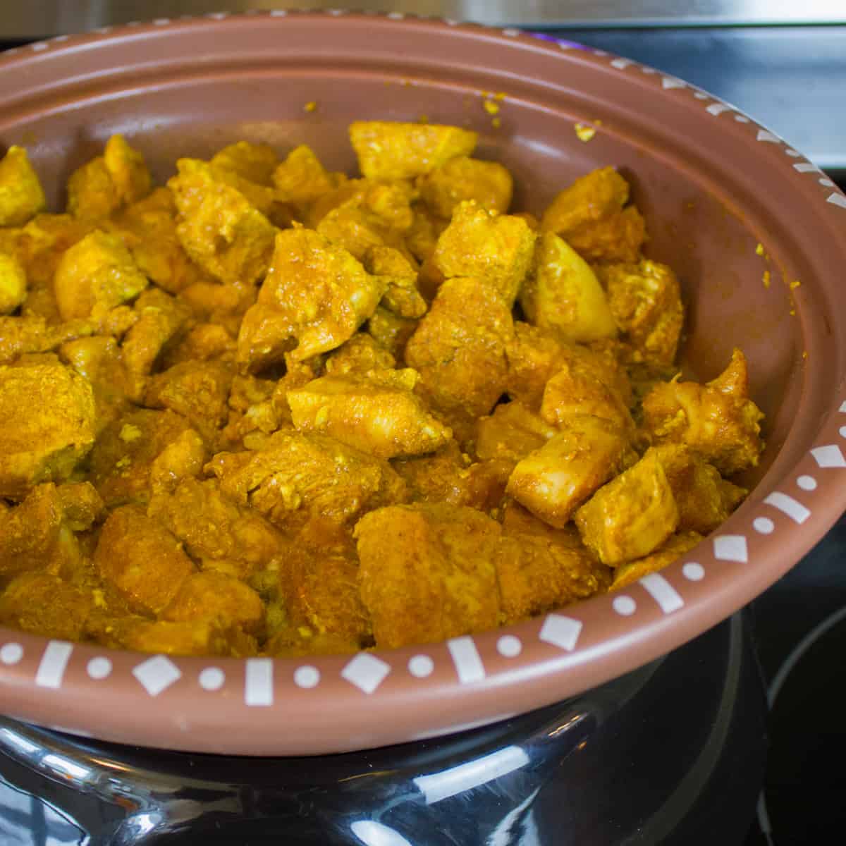 Browning the chicken and seasoning in a skillet.