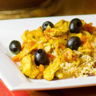 Close up picture of chicken and black olive tagine.