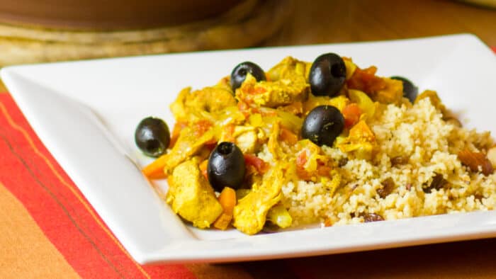 Close up picture of chicken and black olive tagine.