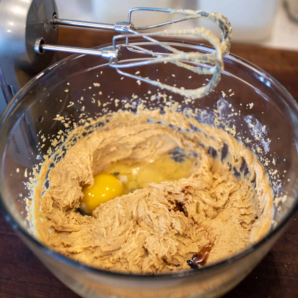 Mixing wet ingredients for the cookies in a glass bowl.