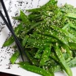 A plate of stir fried snow peas.