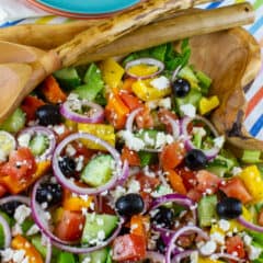 An overhead picture of salad in a wooden serving bowl.