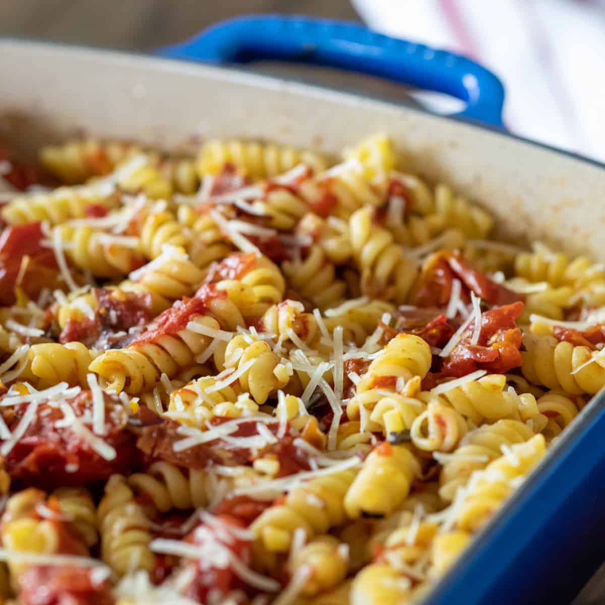 Pasta with tomatoes and parmesan cheese.