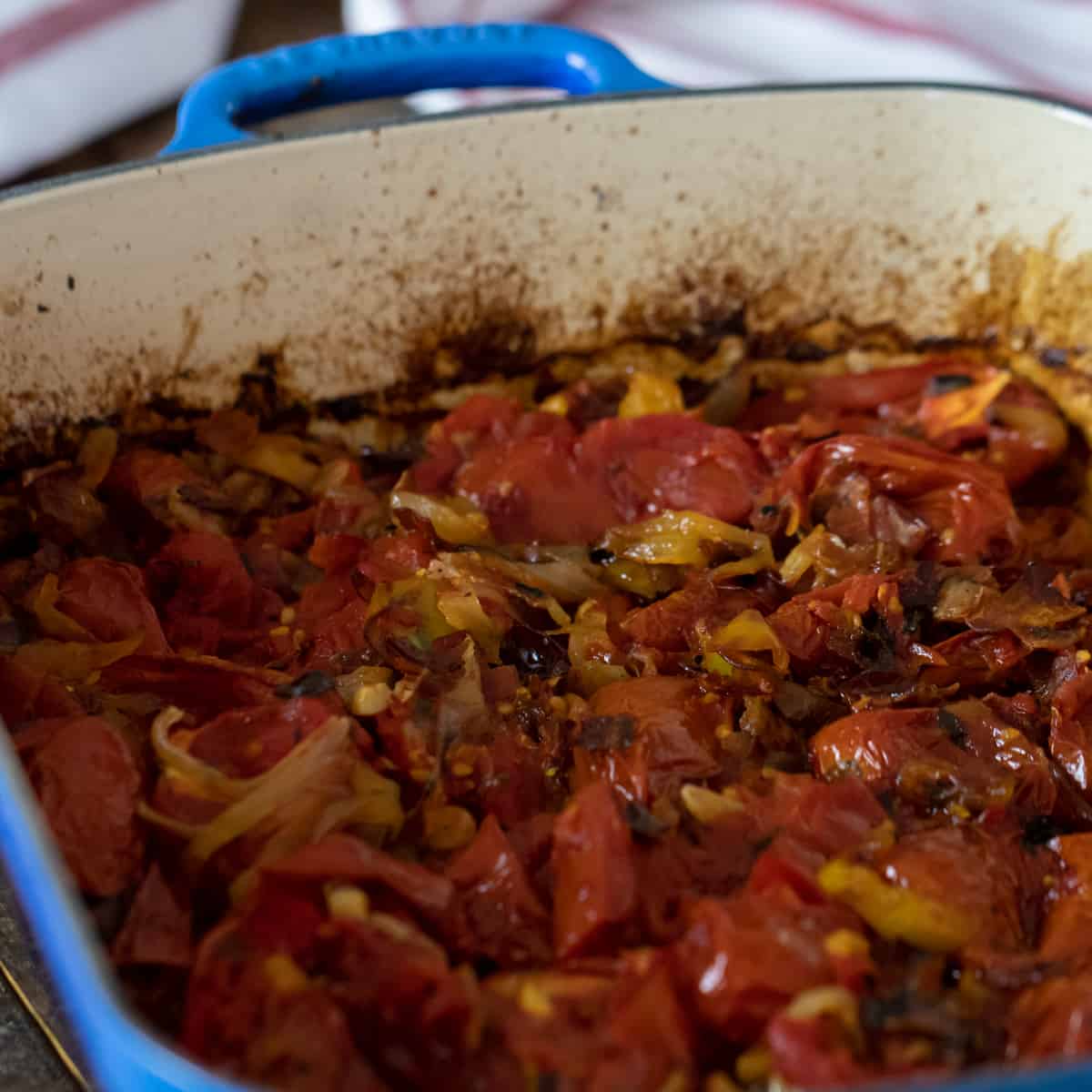 Oven roasted tomatoes in a baking dish.