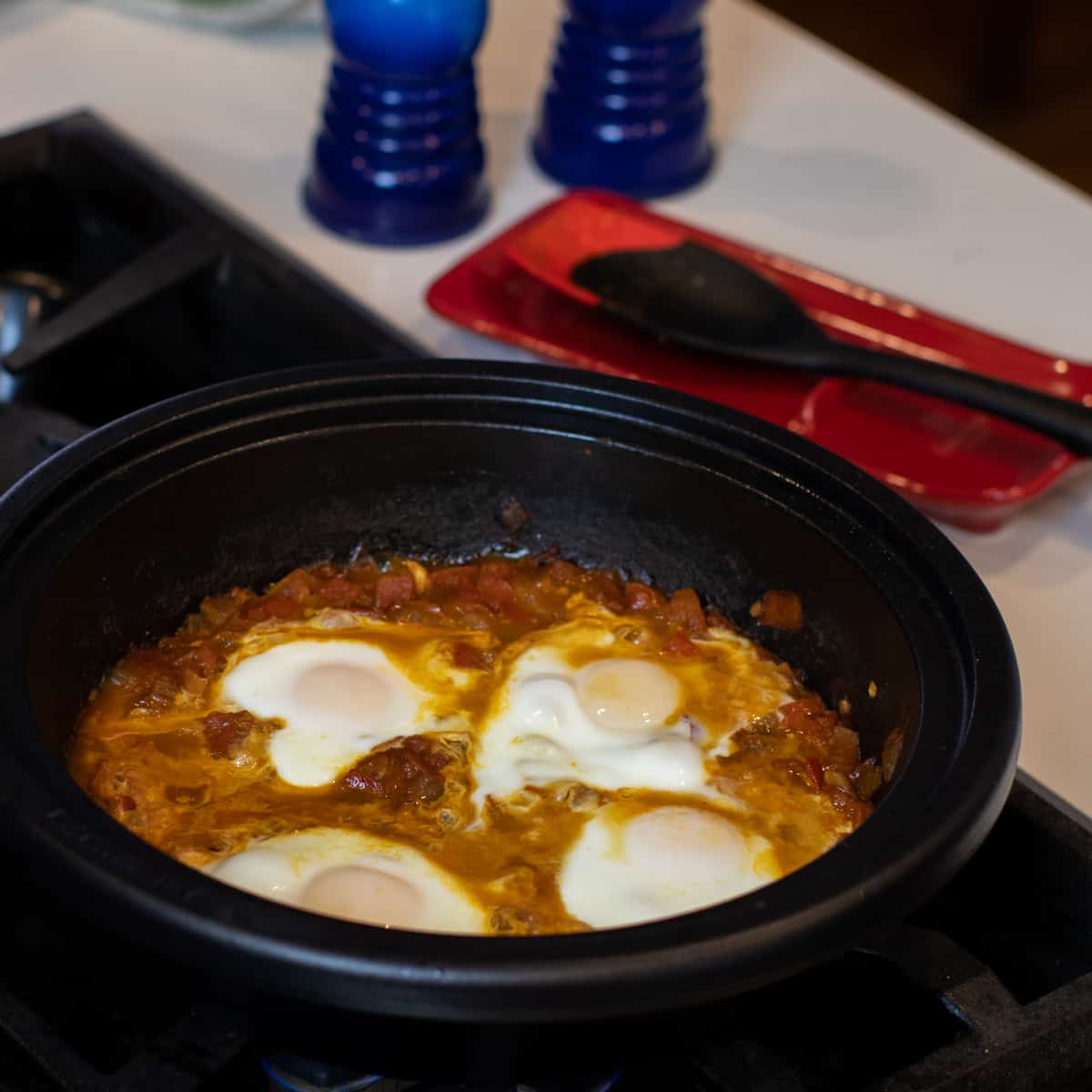 Four eggs poached with tomatoes.