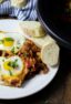 Cooked eggs on a bed of stewed tomatoes.