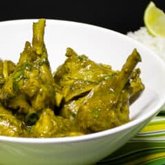 A serving dish of curry chicken drumsticks.