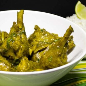 A serving dish of curry chicken drumsticks.