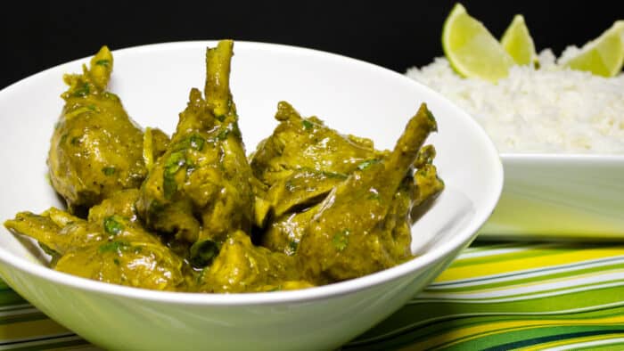 A serving dish of curry chicken drumsticks.