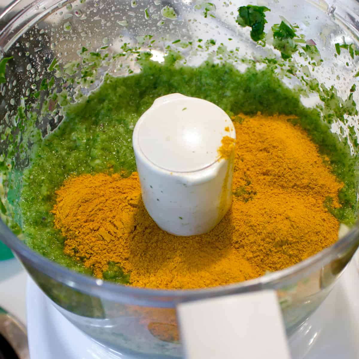 Curry powder dumped into the food processor with blended paste.