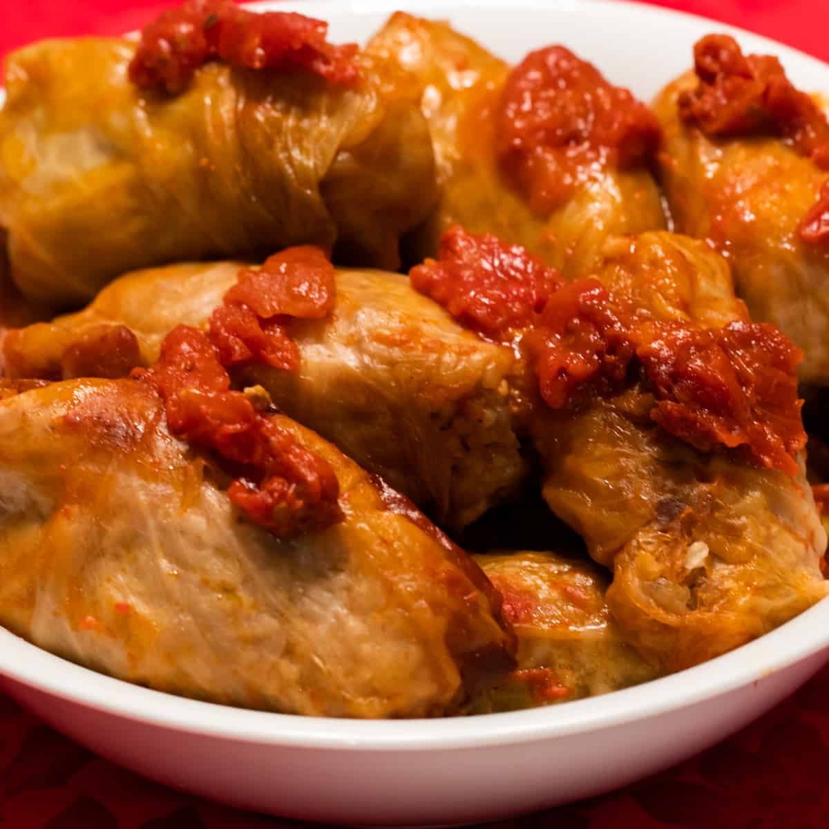 A serving bowl filled with cabbage rolls.