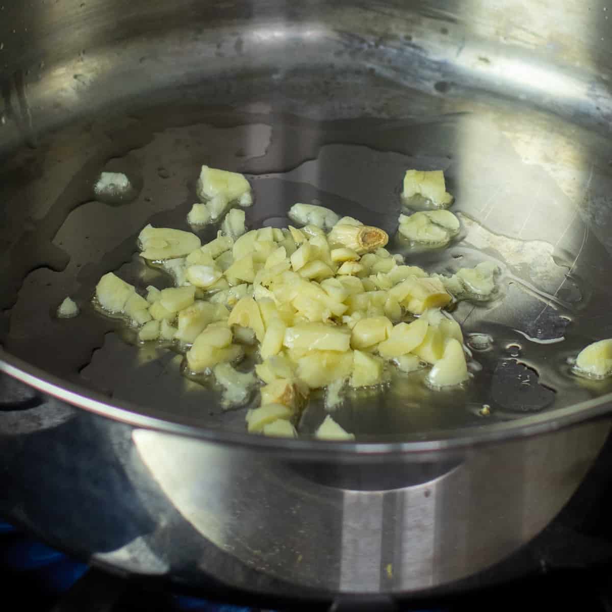 Minced garlic in a skillet with hot oil.