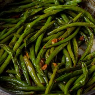 Sautéed green beans in a fry pan.