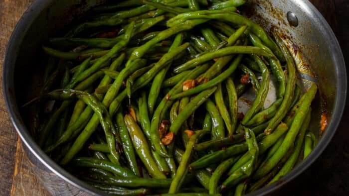 Sautéed green beans in a fry pan.