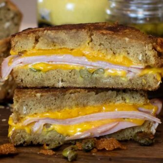 Grilled ham and cheese sandwich cut in half and stacked.