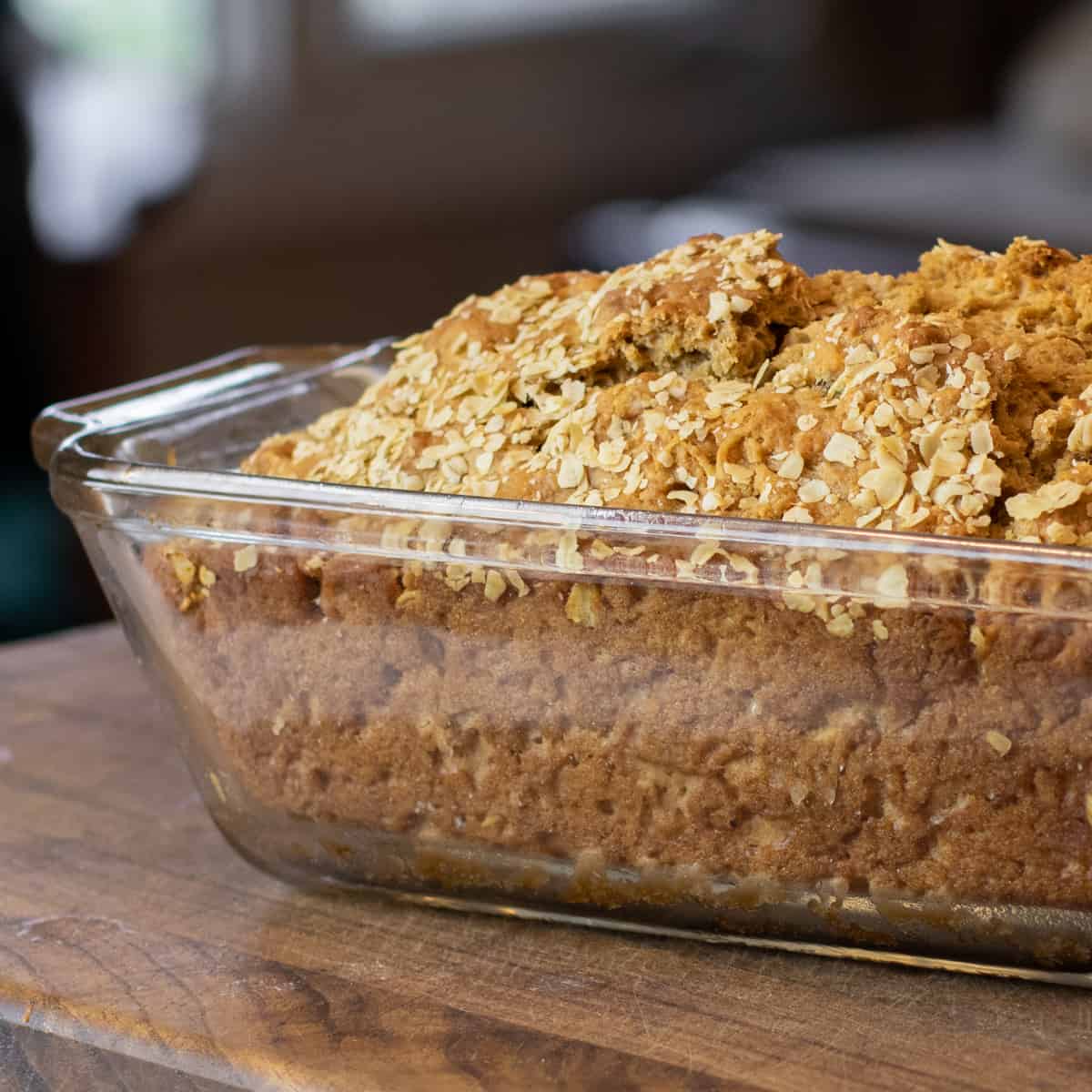 Freshly baked beer bread still in the glass loaf pan.