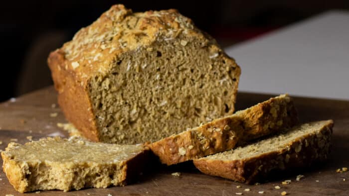 A loaf of beer bread with a couple slices.