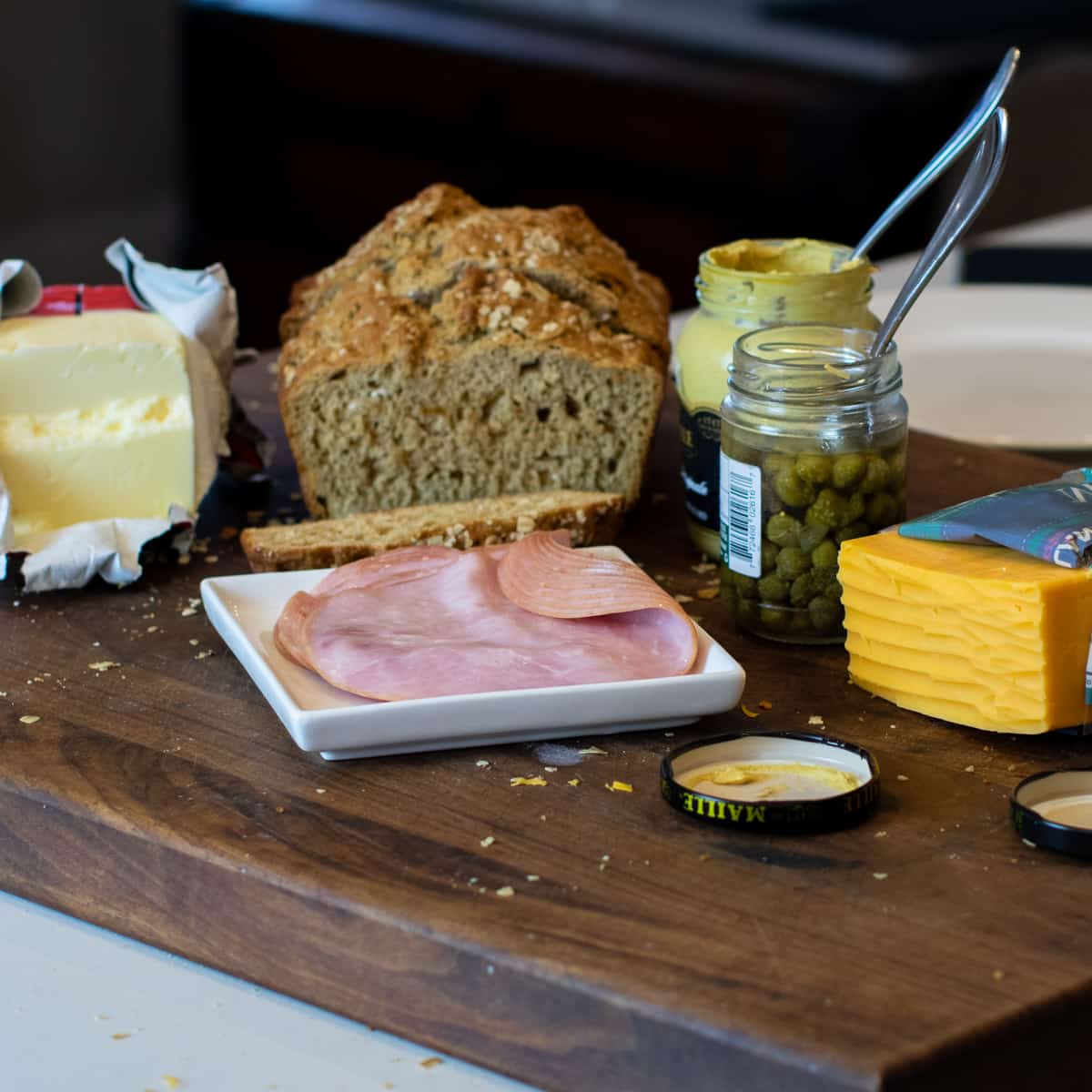 Ingredients for the grilled cheese sandwich on a cutting board.