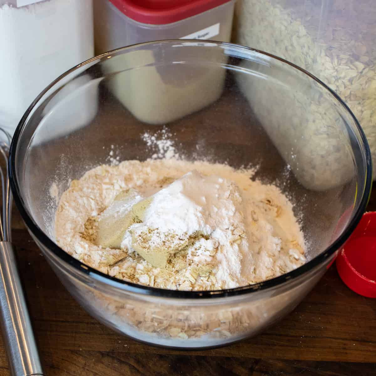 Dry ingredients dumped into a glass bowl.