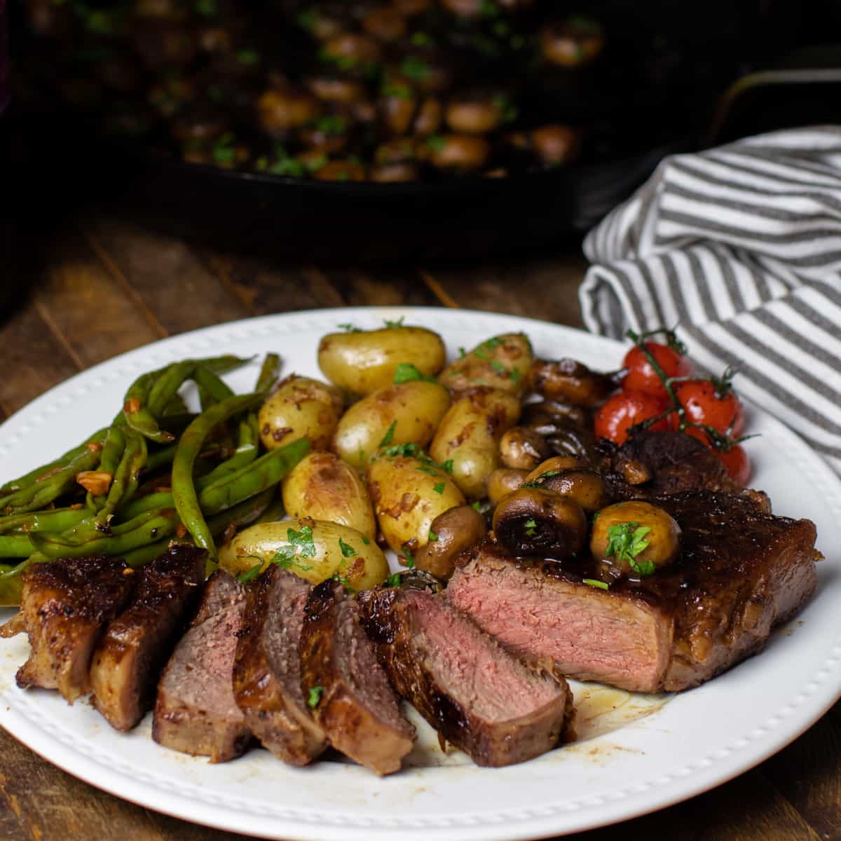 Sliced medium rare steak on a plate.