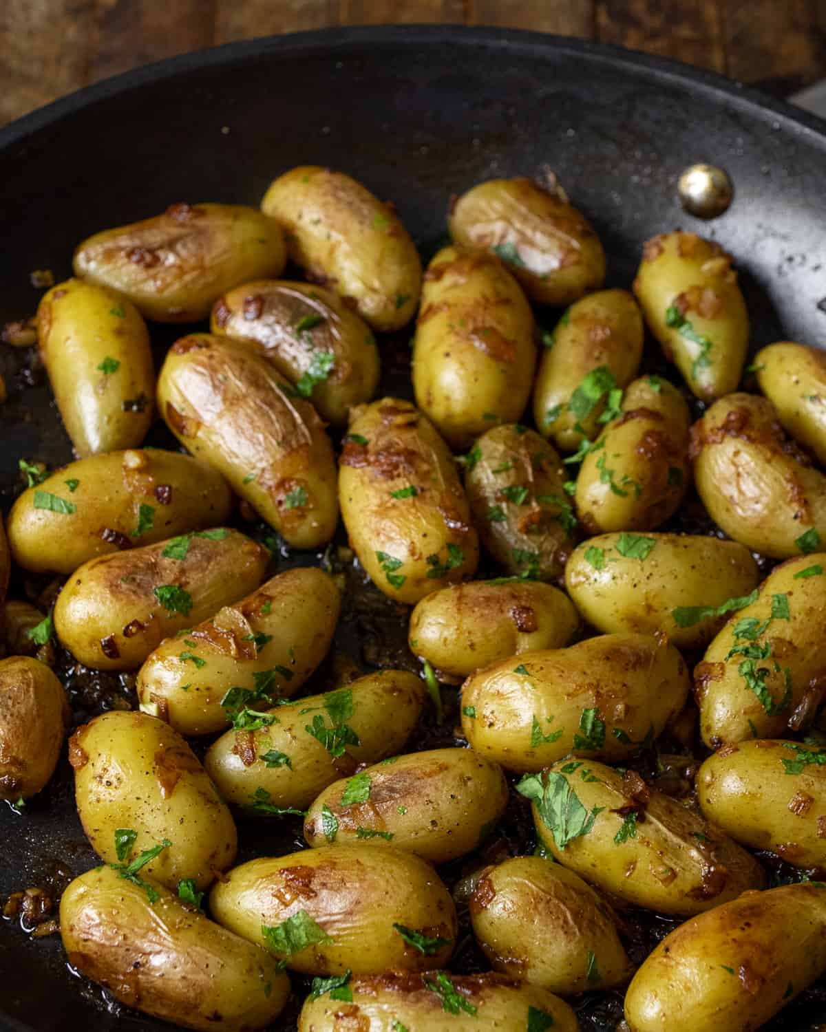 Fresh parsley sprinkled all over the cooked mini potatoes.