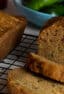 Loaves of fresh baked zucchini bread on a cooling rack.