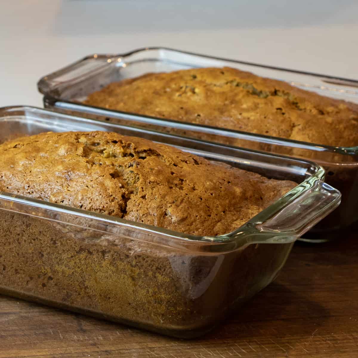 Fresh baked zucchini bread in the glass loaf pans.