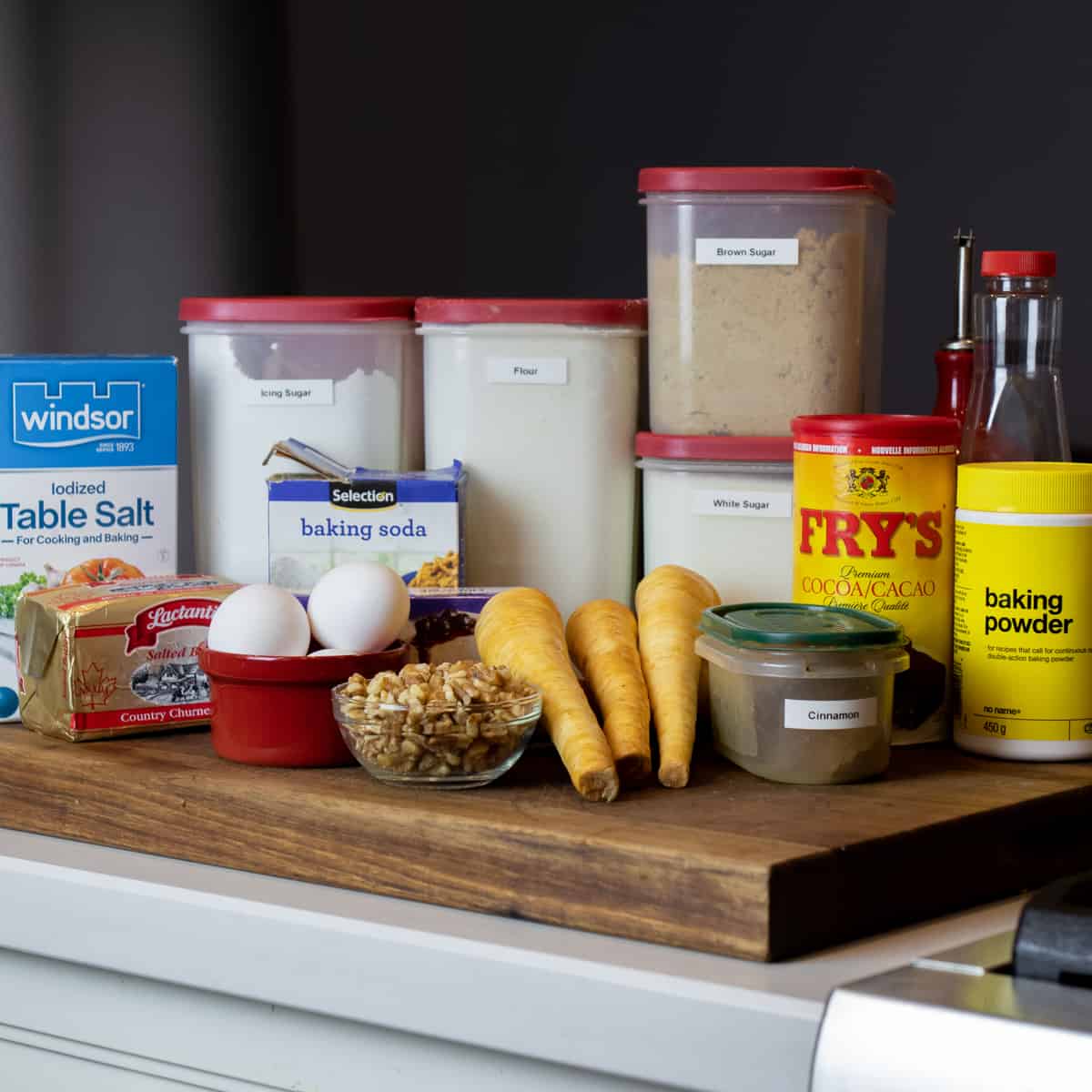 Ingredients needed for cake collected on a cutting board.