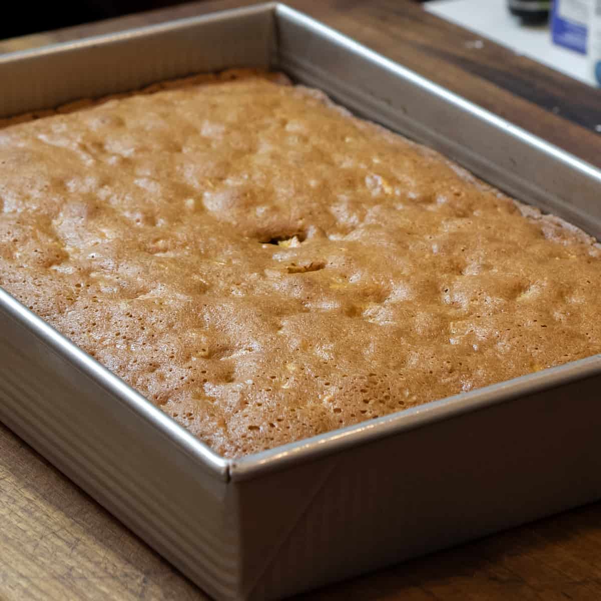 Baked cake in a rectangular metal dish.