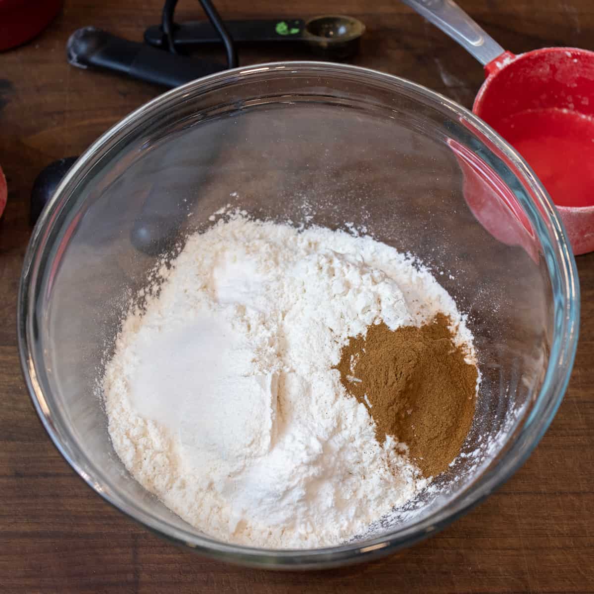 Flour and other dry ingredients in a glass bowl.