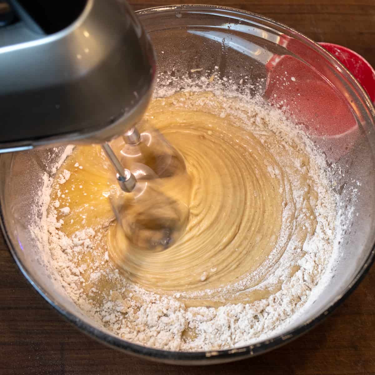 Dry ingredients getting mixed in with the wet ingredients.