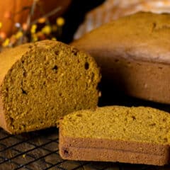 Two pumpkin loaves. One whole and one sliced.