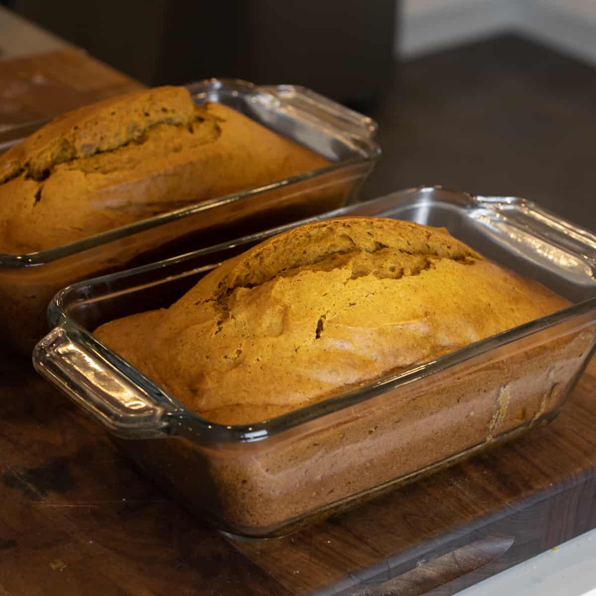 Fresh baked pumpkin loafs in glass loaf pans.
