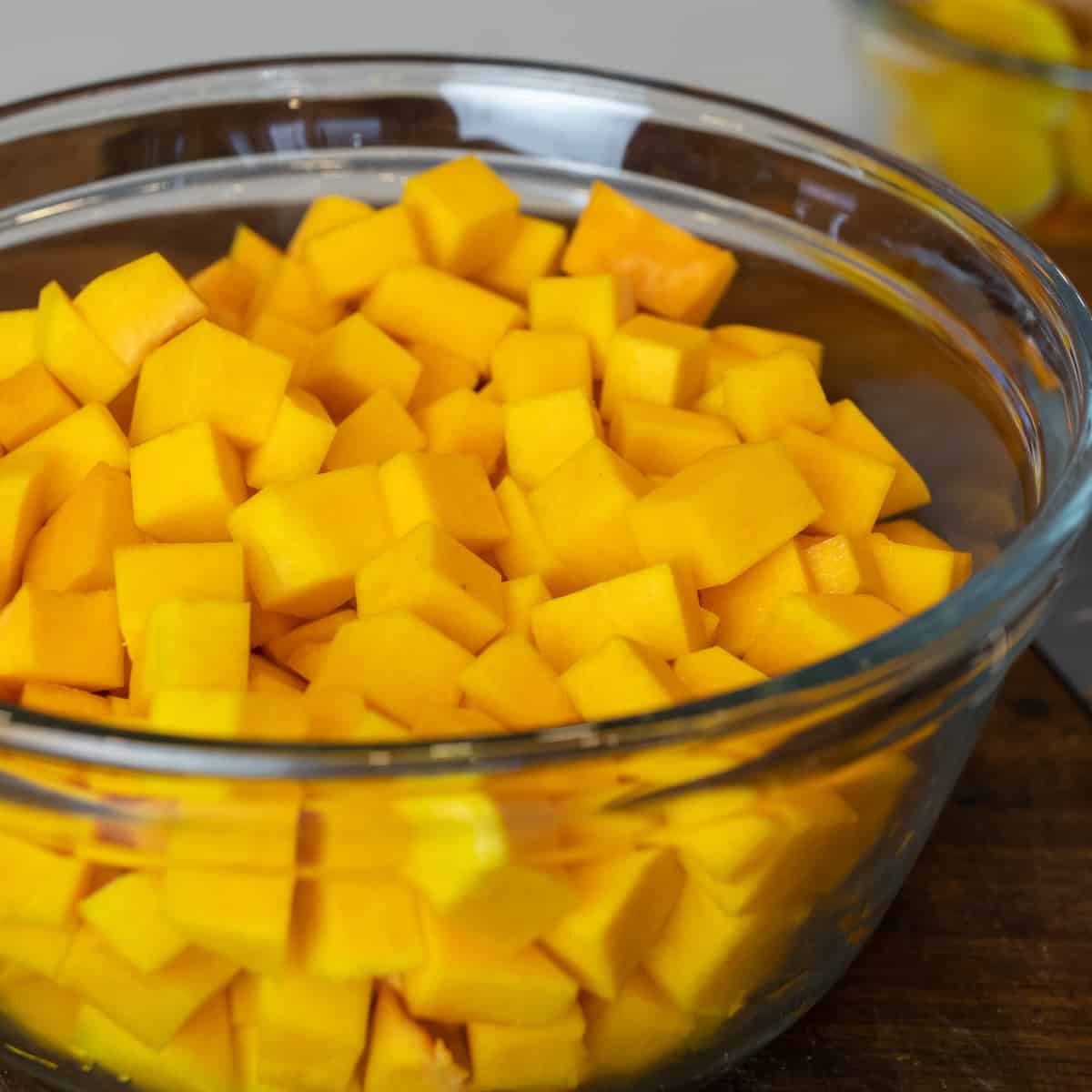 Cubes of butternut squash in a large glass bowl.