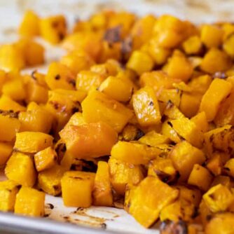 Roasted cubes of butternut squash piled together.