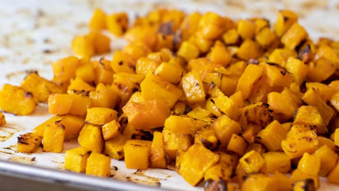 Roasted cubes of butternut squash piled together.