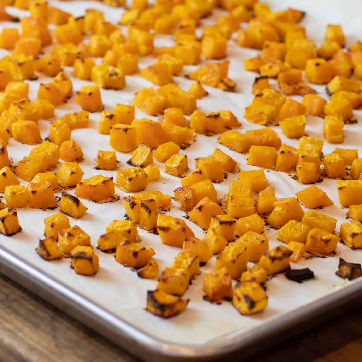 Baked squash fresh out of the oven and still on a baking sheet.