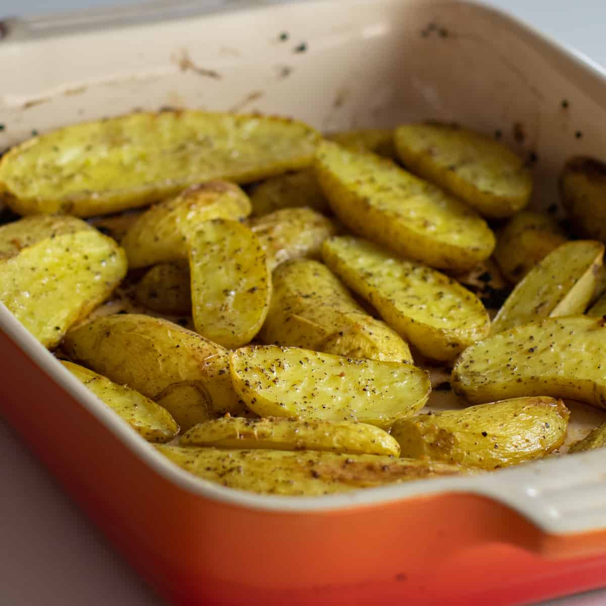 Halved fingerling potatoes cooked in a baking dish.