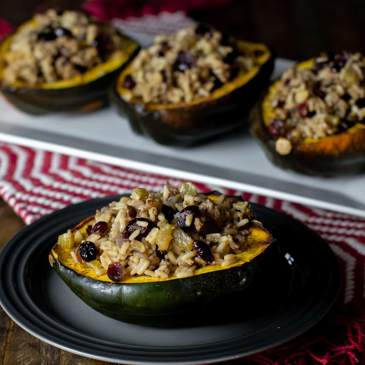 Stuffed squash on a platter with one in front on a plate.