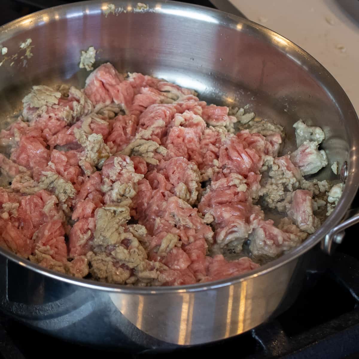 Ground turkey cooking in a skillet.