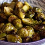 Brussels sprouts halves roasted in a bowl.