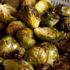 A shallow bowl piled with Brussels sprouts.