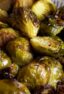 A shallow bowl piled with Brussels sprouts.