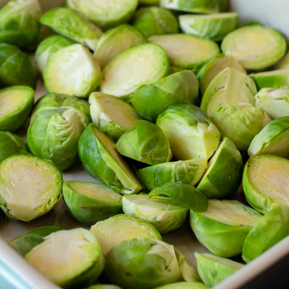 Raw Brussels sprouts cut in half.