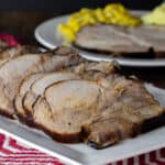 A platter with sliced pork roast.