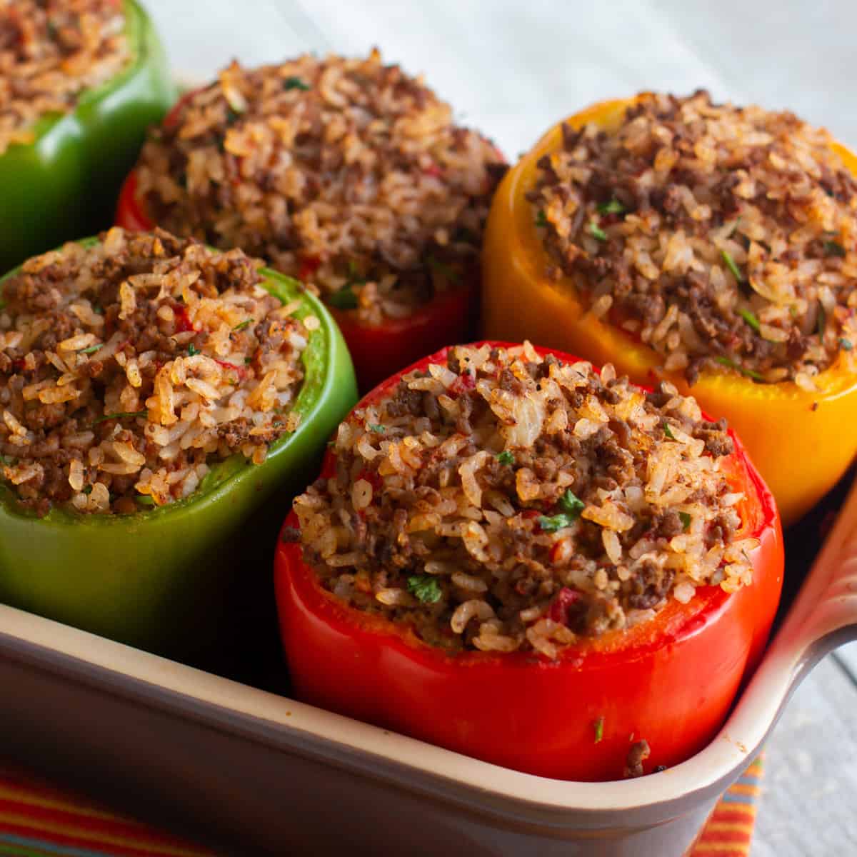 Baked stuffed peppers in a baking dish.