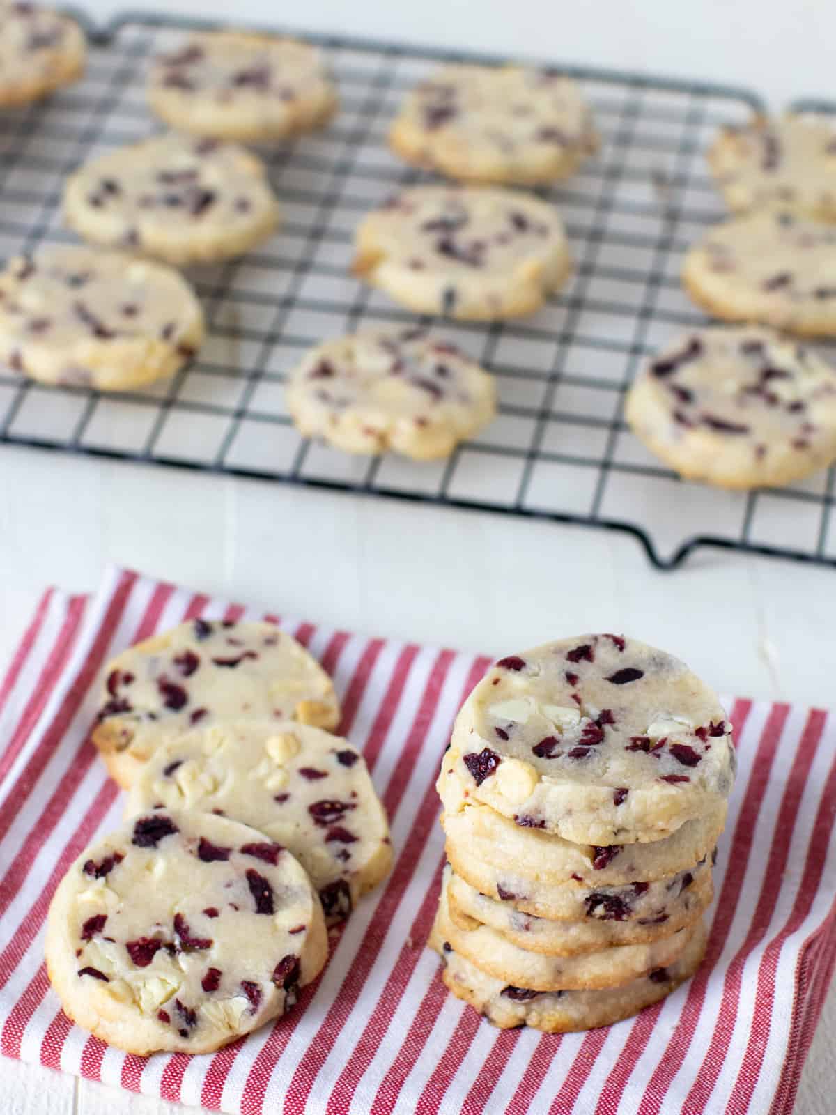 Overhead picture of shortbread cookies stacked and on a cooling rack.